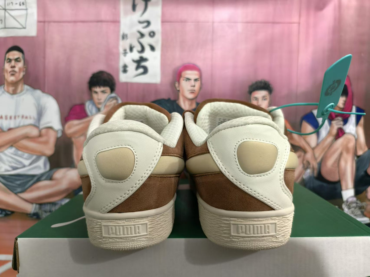 Rear view of brown PUMA low-top sneakers with cream heel panels and textured soles