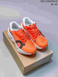 Pair of orange ON Cloudmonster 3 Hyper sneakers displayed on a cardboard box, with white midsoles and black details.