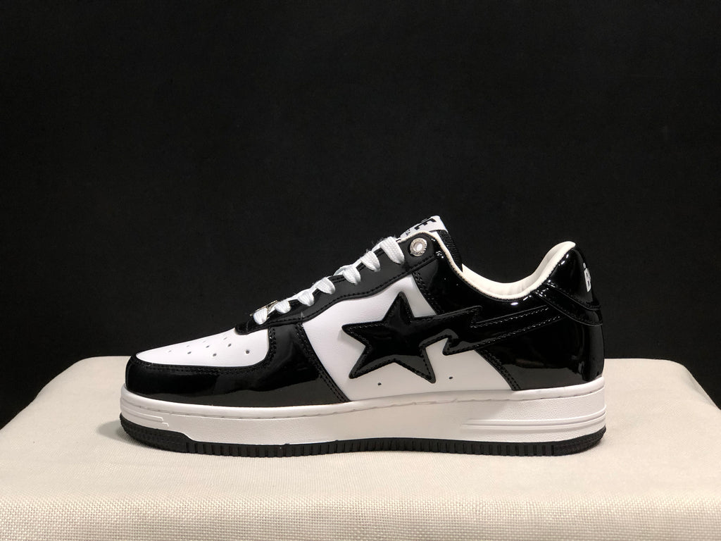 Side profile emphasizing the glossy black heel and toe overlays, white side panel and low-top silhouette.