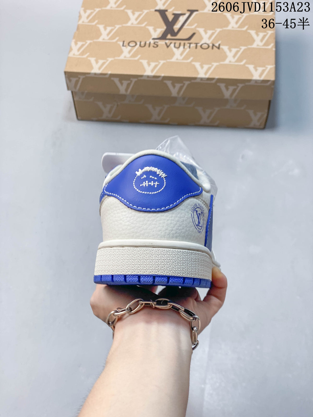 Rear view showing blue heel panel and off-white midsole
