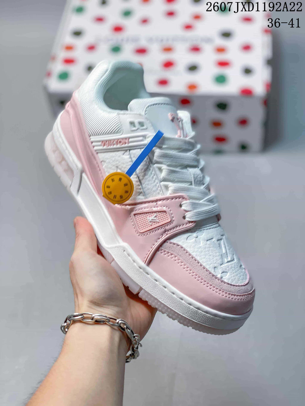 Angled side view showing the monogram upper, pink overlays, padded collar and rubber sole.