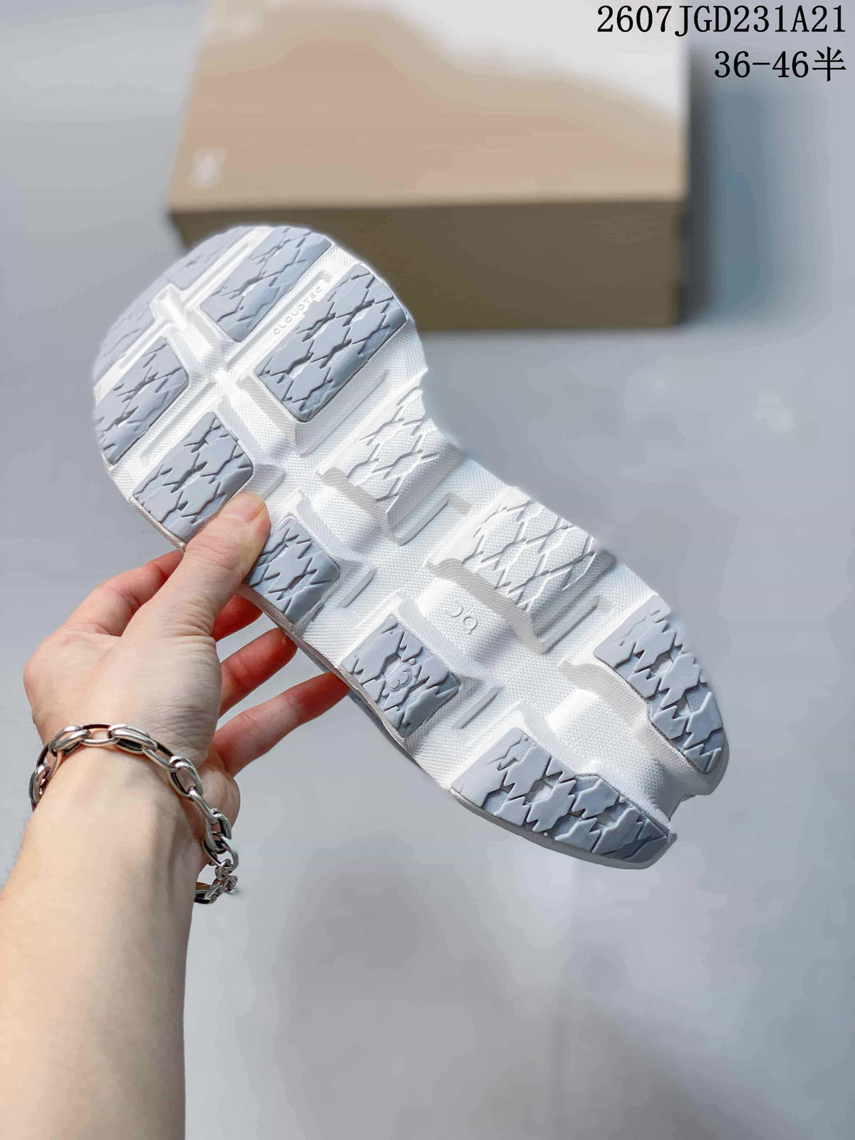 Outsole view showing the segmented white and gray tread pattern of the sneakers.