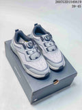 Pair of gray and white DESCENTE Circuit 2.0 Wire sneakers displayed on a branded shoebox, with a BOA dial closure visible.