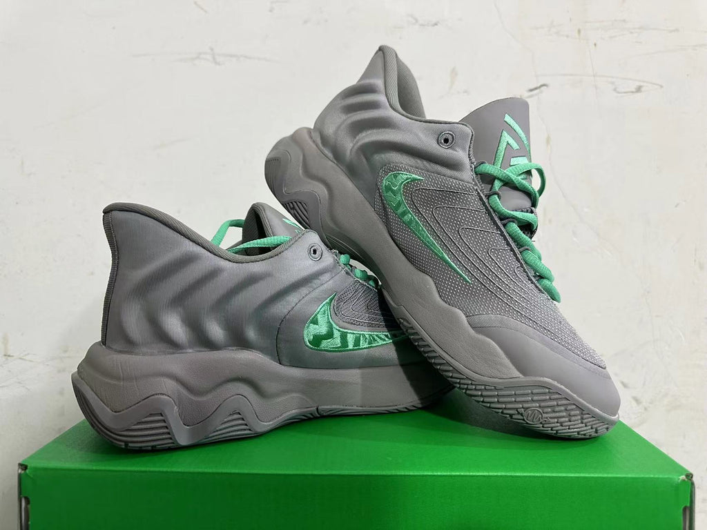 Pair of grey Nike KD 4 basketball shoes with green accents, shown from the side