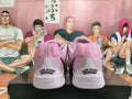 Rear view of pink and light gray basketball shoes with heel lettering