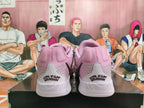 Rear view of pink and light gray basketball shoes with heel lettering