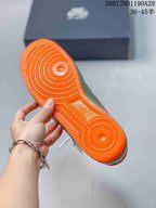 Close-up of the bright orange textured outsole with circular traction patterns.