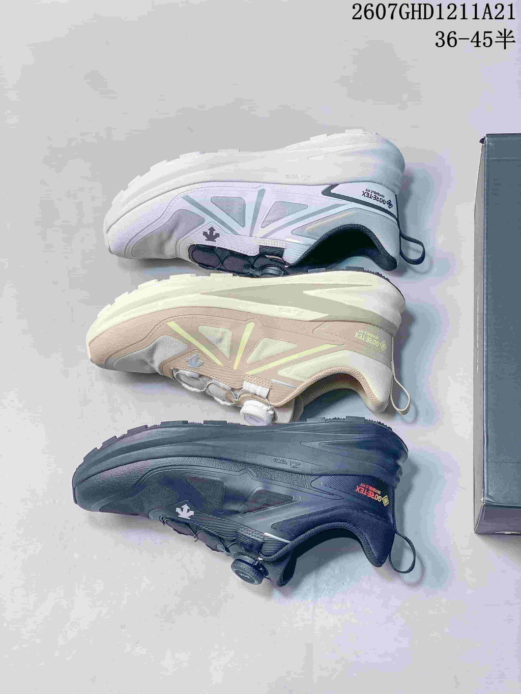 Three color versions of the DESCENTE sneaker arranged to show their side profiles and outsoles.