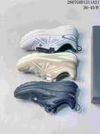 Three color versions of the DESCENTE sneaker arranged to show their side profiles and outsoles.