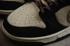 Close-up of the perforated beige toe box, black overlay, and cream-colored midsole.