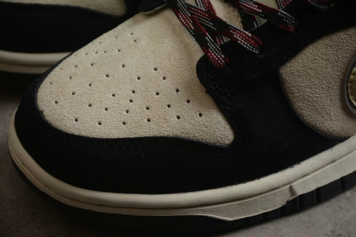 Close-up of the perforated beige toe box, black overlay, and cream-colored midsole.