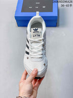Top view of the white lace-up sneaker showing the textured toe area and branded tongue.