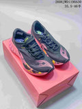 Pair of dark Saucony Endorphin Pro 4 running shoes with pink and multicolor accents on a pink box