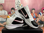 Pair of black, white, and red Nike basketball shoes shown at an angle.