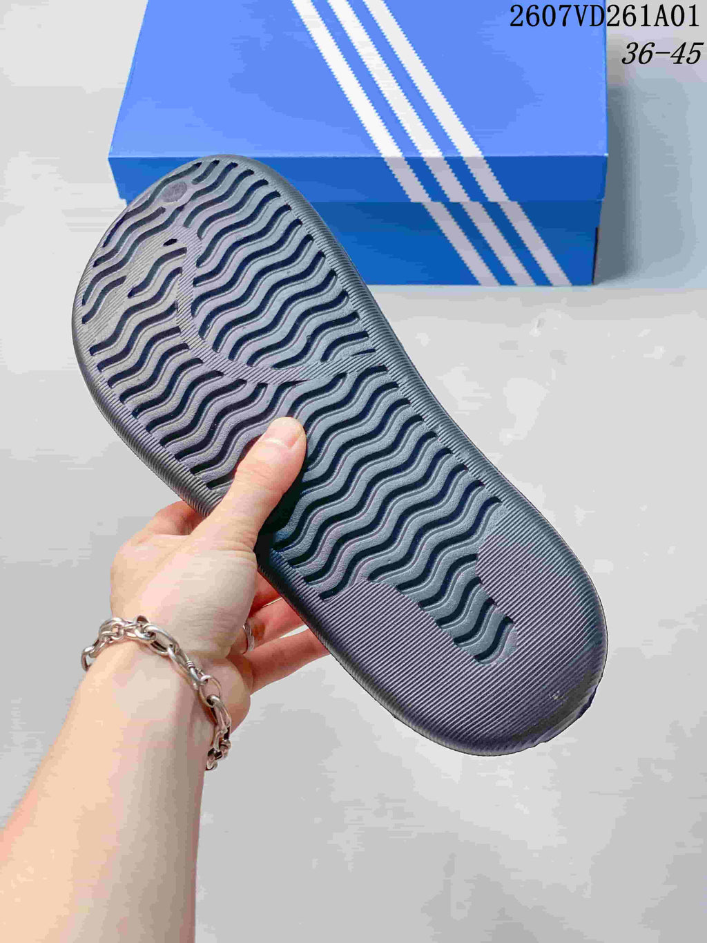 Close-up of the textured outsole on a dark mule clog.