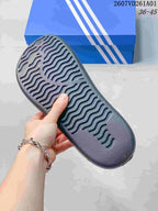 Close-up of the textured outsole on a dark mule clog.