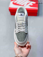 Top view showing the white laces, padded tongue, perforated grey toe panel, and visible Louis Vuitton tongue branding.