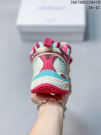 Rear view of the sneaker showing the layered heel construction and red, white, and turquoise color blocking.