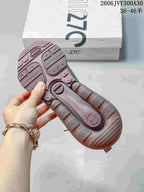 Underside of a mauve sneaker showing the textured outsole