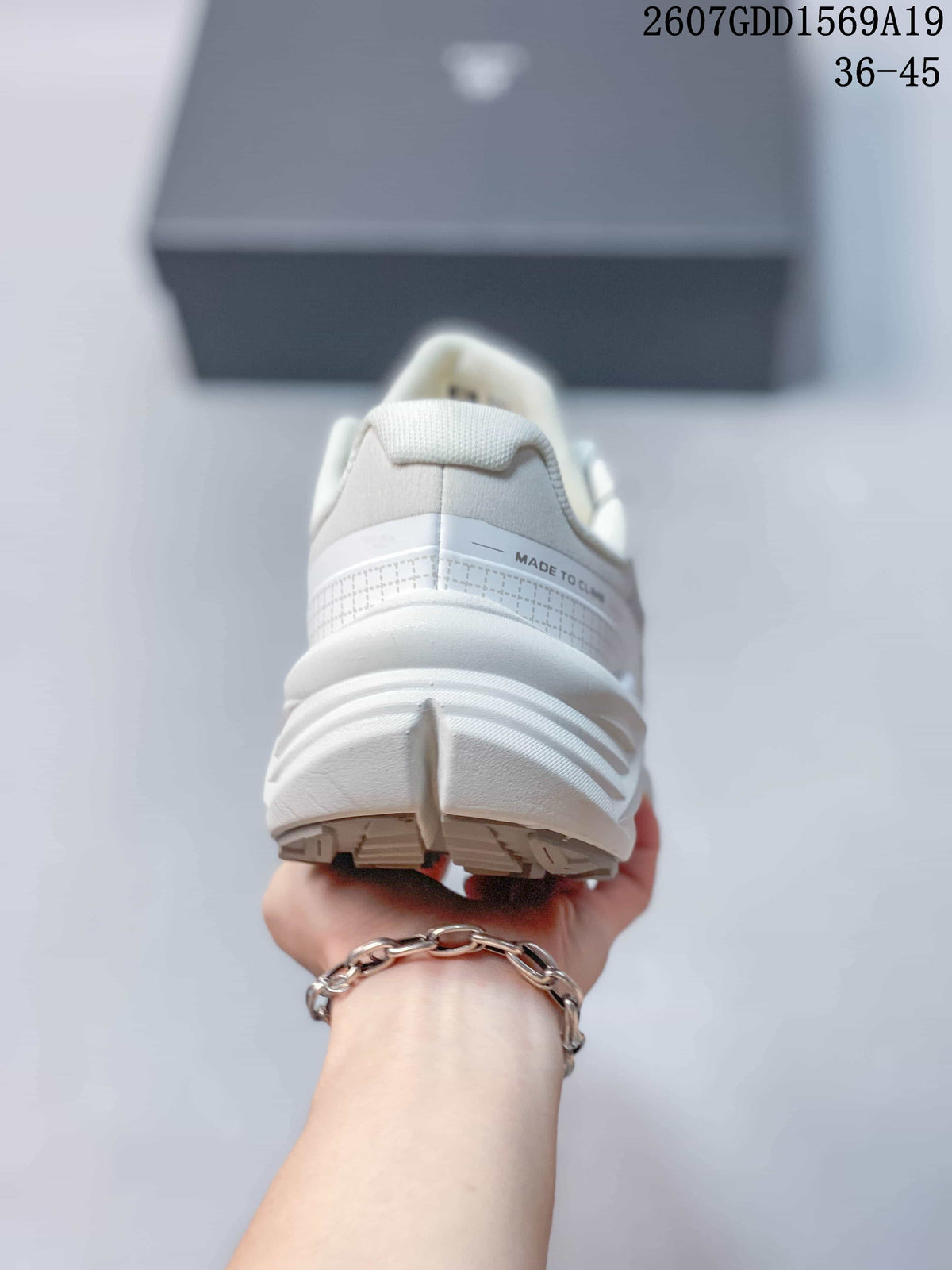 Rear view of the white sneaker showing the padded collar, layered heel construction and outsole edges.