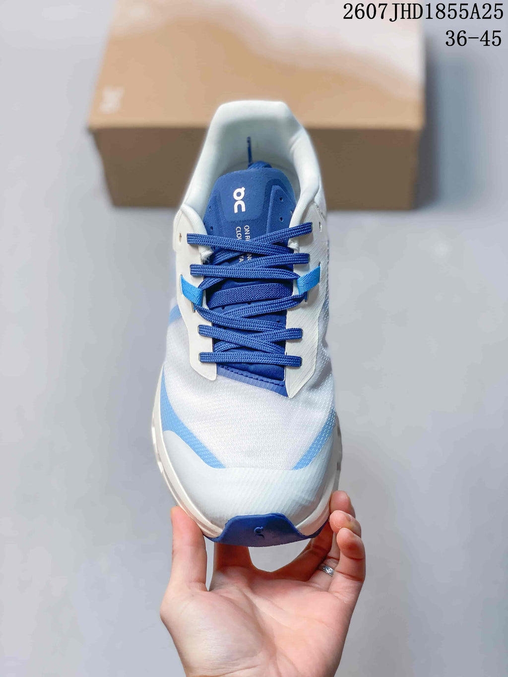 Top view of the sneaker showing blue laces, a blue tongue, white upper panels, and light blue accents.