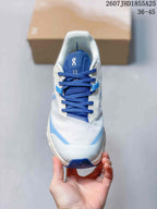 Top view of the sneaker showing blue laces, a blue tongue, white upper panels, and light blue accents.