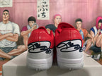 Rear view of red and white basketball shoes with black outlined heel detailing