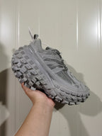 Angled front view of the grey Balenciaga Defender sneaker highlighting the mesh panels, overlays and textured outsole.