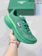 Green Lacoste Neo Run low-top sneaker with a lace-up closure, crocodile side logo, and layered sculpted sole; size range text 36–45 is visible.