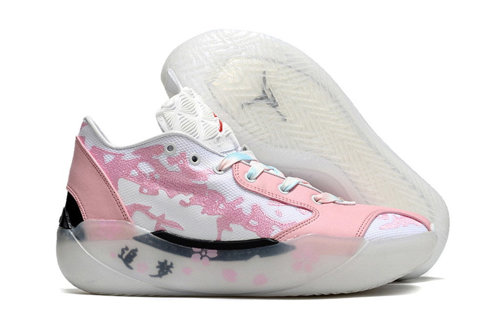 Side view of pink and white Jordan Luka 39 shoes with outsole visible