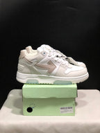Side view of the white low-top sneakers showing layered panels, arrow graphics, padded collars, and translucent outsole sections.