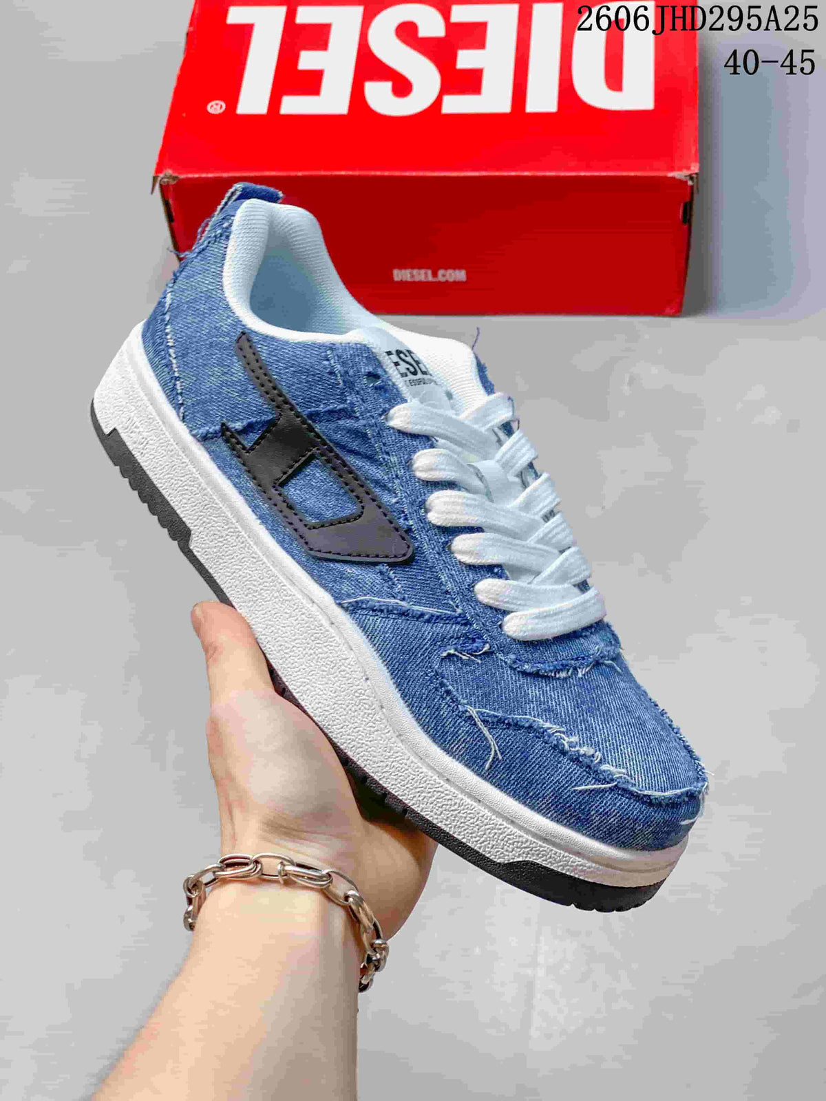 Angled side view of the blue distressed denim-look sneaker with black side detail and white laces.