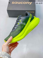 Side view of a gray Saucony running shoe with a vivid yellow sole