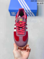Top-down view of the burgundy sneaker with red laces and adidas tongue branding.