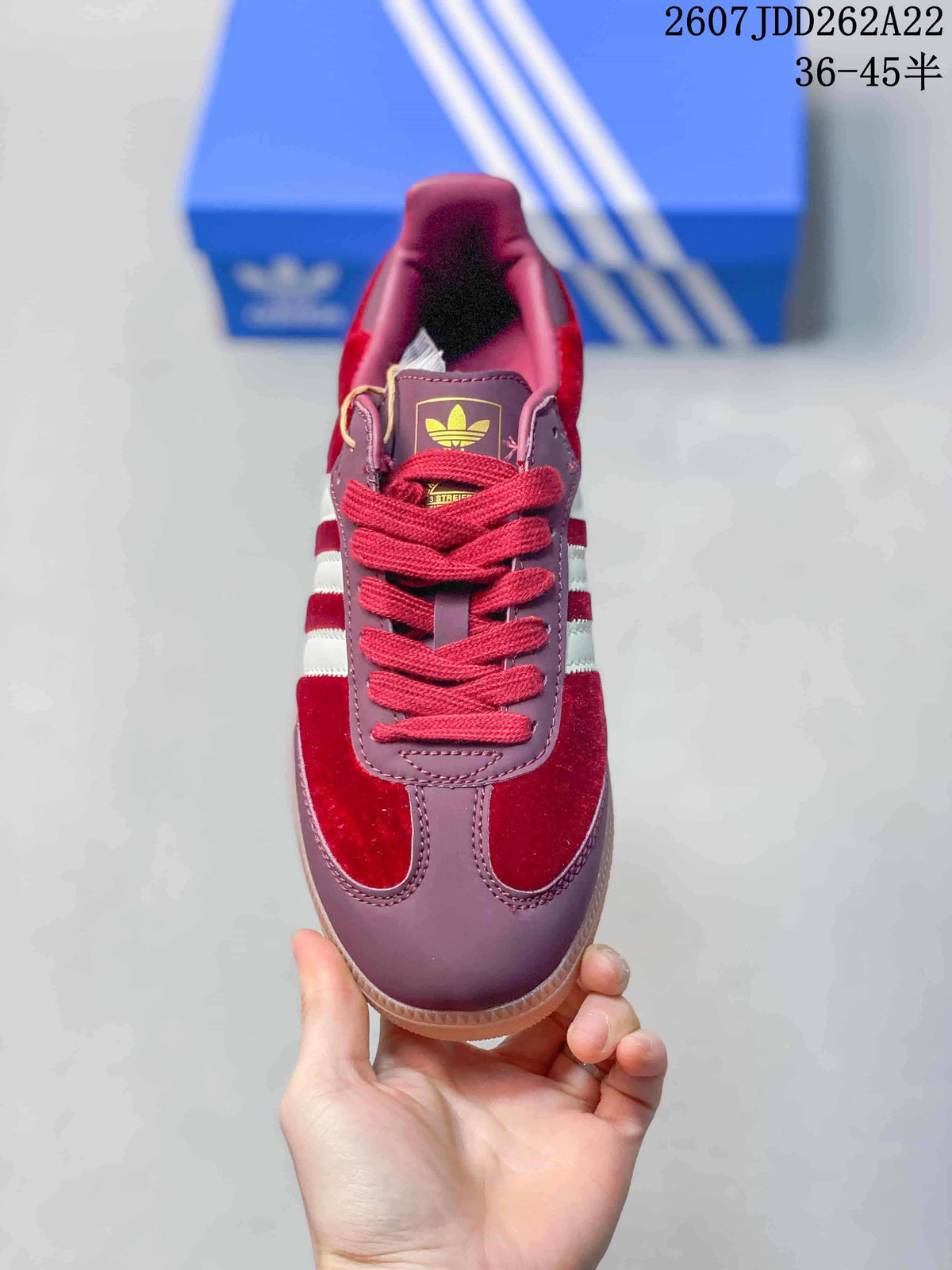Top-down view of the burgundy sneaker with red laces and adidas tongue branding.