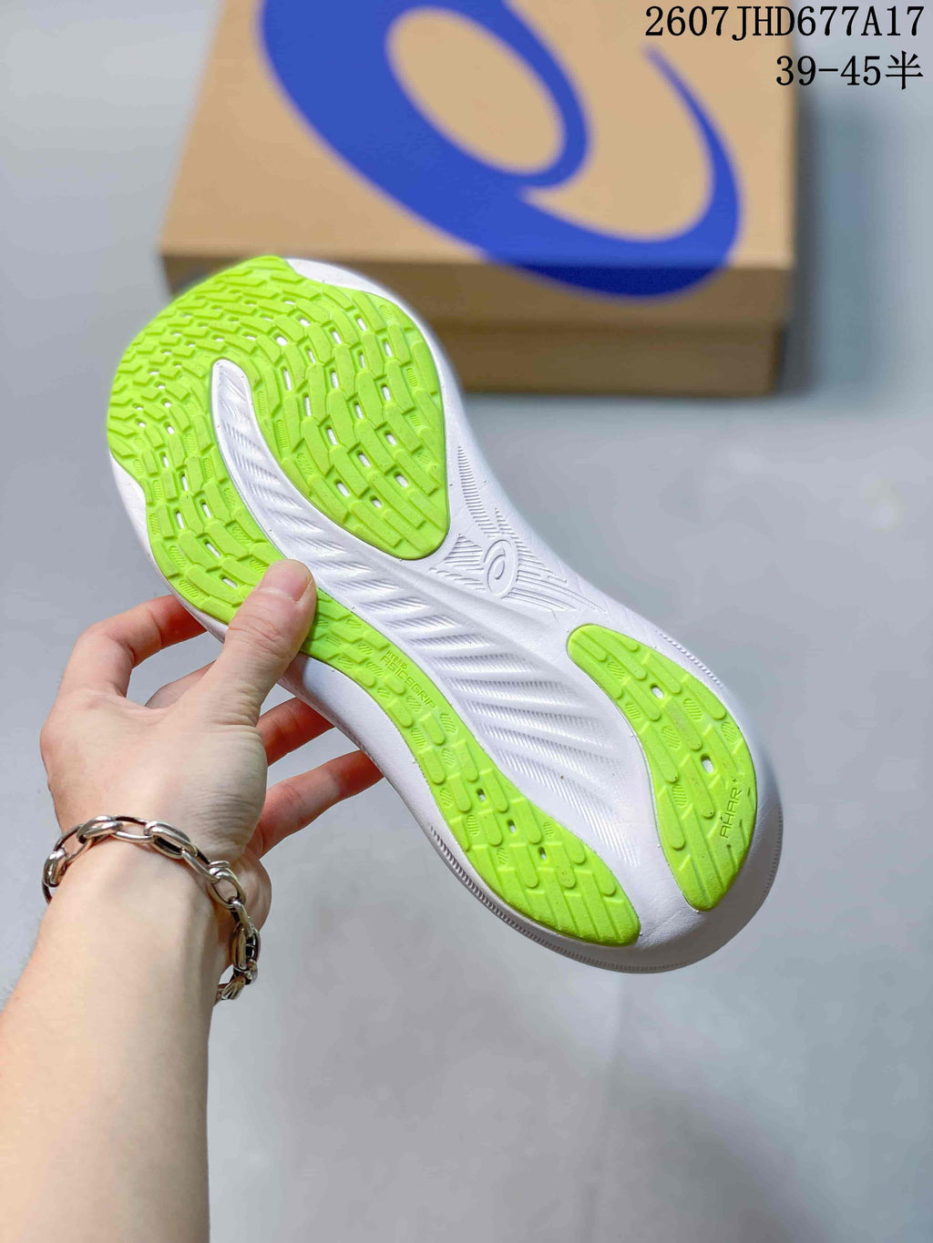 Close view of the shoe outsole showing bright green rubber sections and a white midsole.