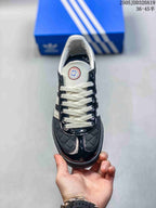 Top view showing the white laces, black eyelet panels, quilted upper and tongue branding.