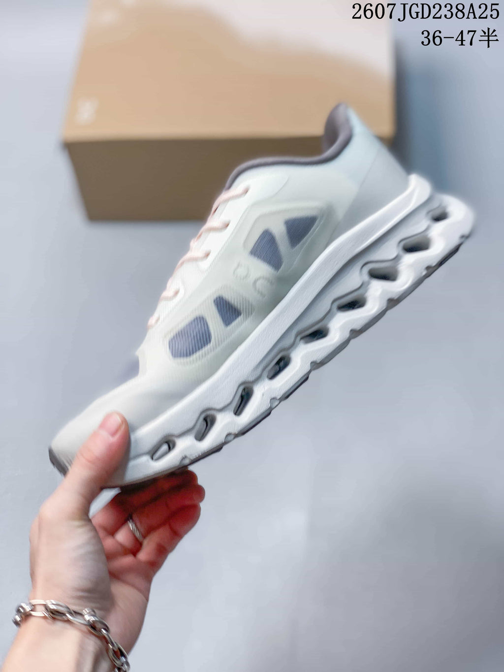 Side view of the sneaker showing the layered upper and segmented sole design.