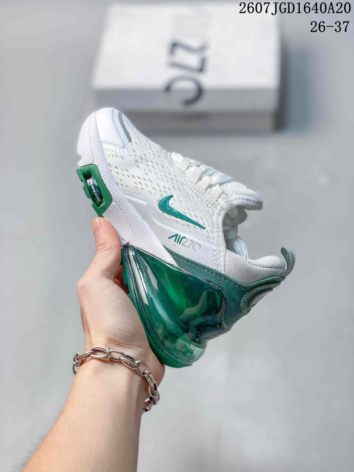 Side view showing the green Nike Swoosh, Air Max 270 branding and translucent heel structure.