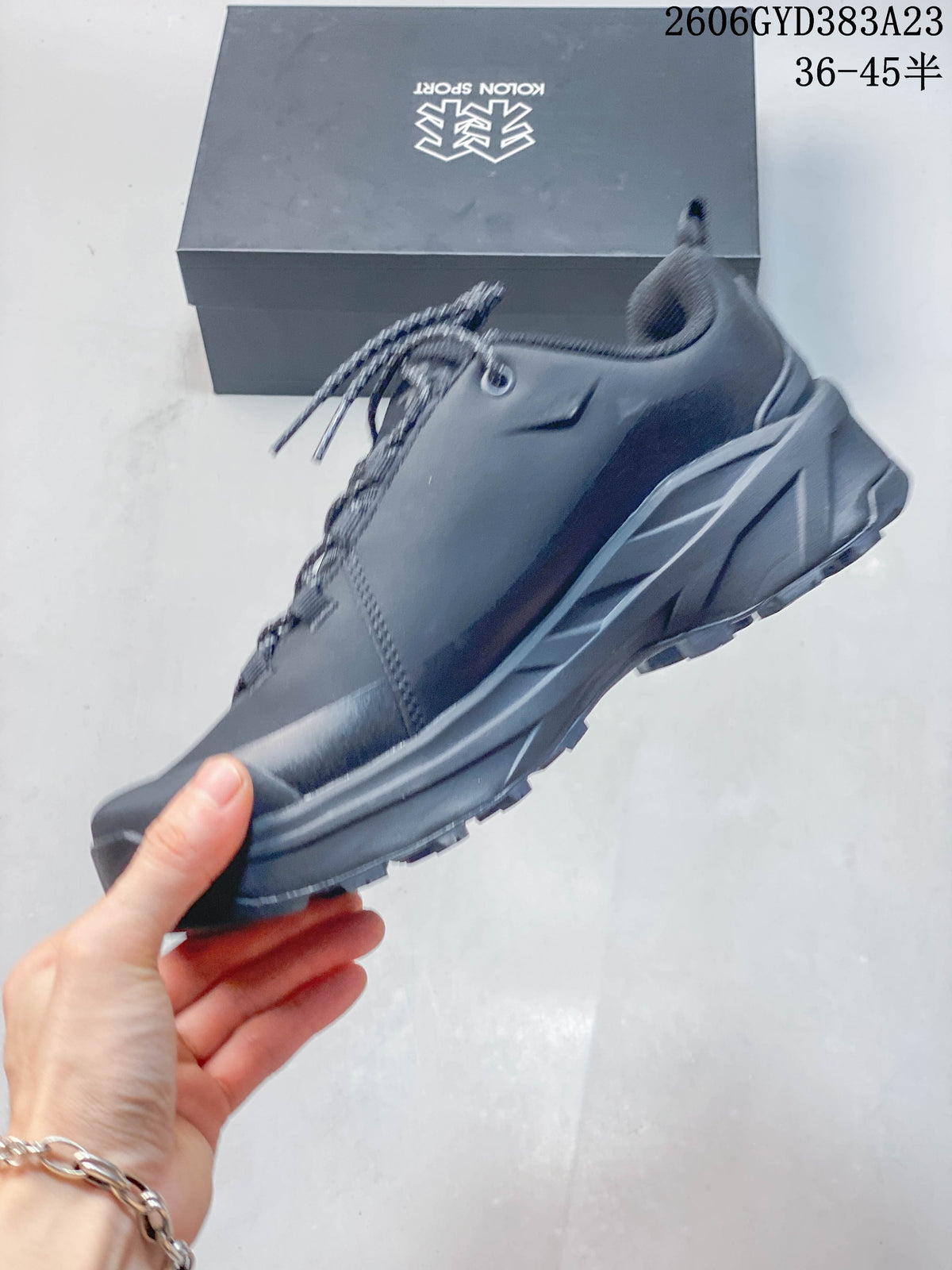 Side view of the low-top outdoor shoe with lace-up fastening