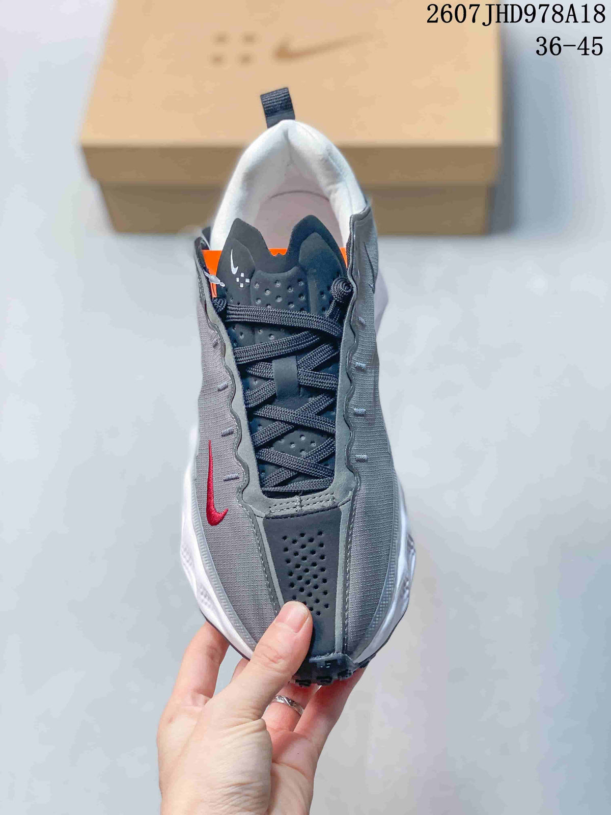 Top view showing the lace-up design, perforated dark panels, gray side panels, and red Swoosh.