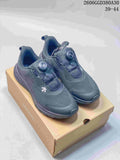Pair of dark gray Descente Fitstep Wire shoes with dial closures, shown on a shoe box