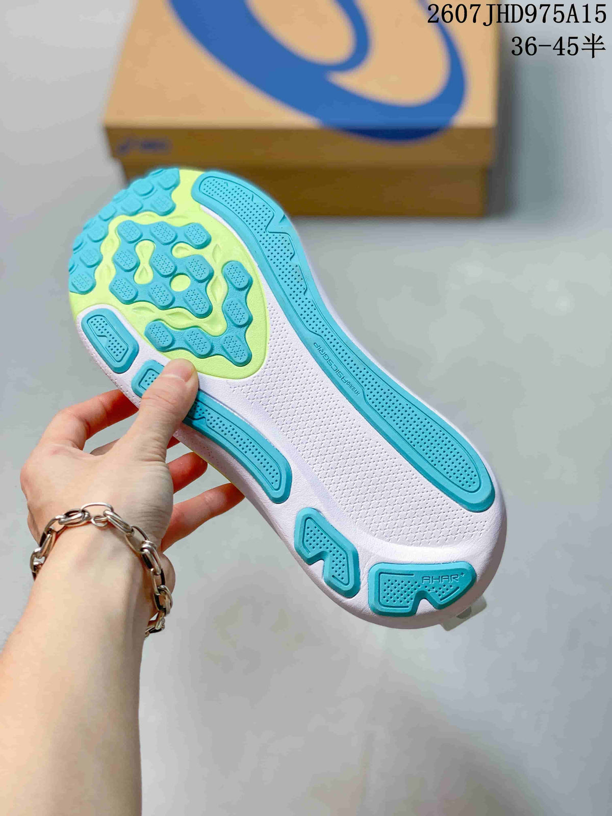 Close-up of the textured outsole showing turquoise-blue and lime-green traction sections.