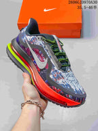 Multicolor Nike Air Zoom Pegasus Premium sneaker with bright red-orange midsole accents and neon lace details.