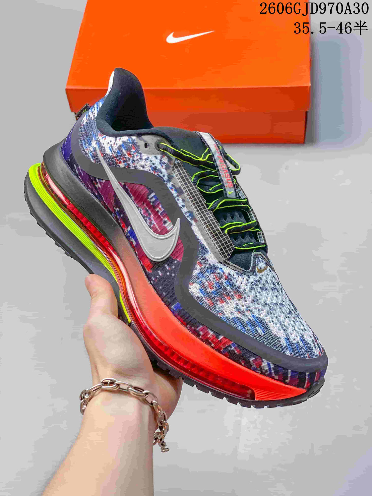 Multicolor Nike Air Zoom Pegasus Premium sneaker with bright red-orange midsole accents and neon lace details.