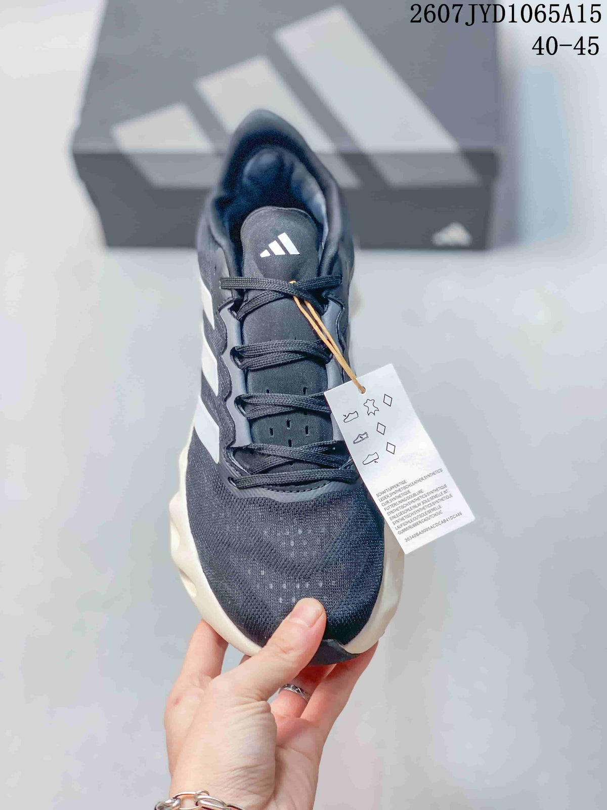 Top view of the lace-up sneaker showing the dark upper, Adidas tongue mark and attached product tag.