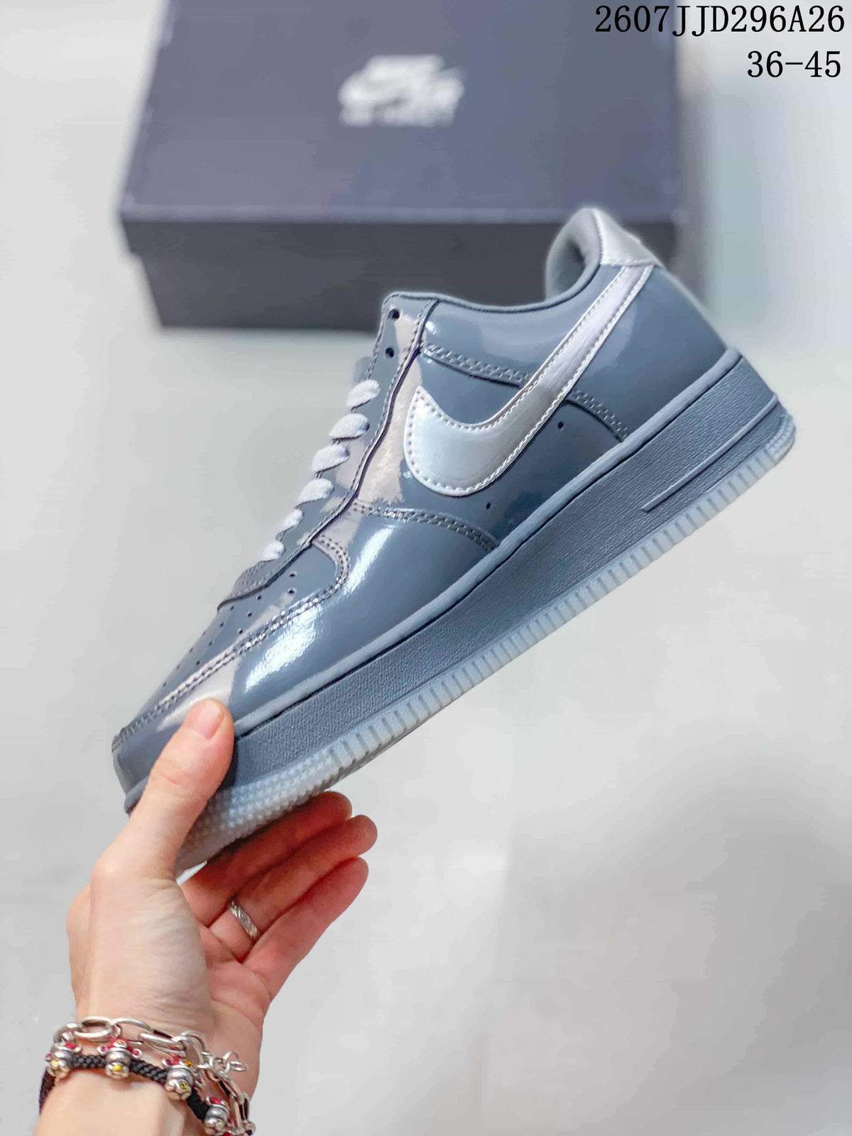 Side view of a grey low-top sneaker showing the contrasting Swoosh, stitching, perforations and rubber outsole; image text shows 2607JJD296A26 and 36–45.
