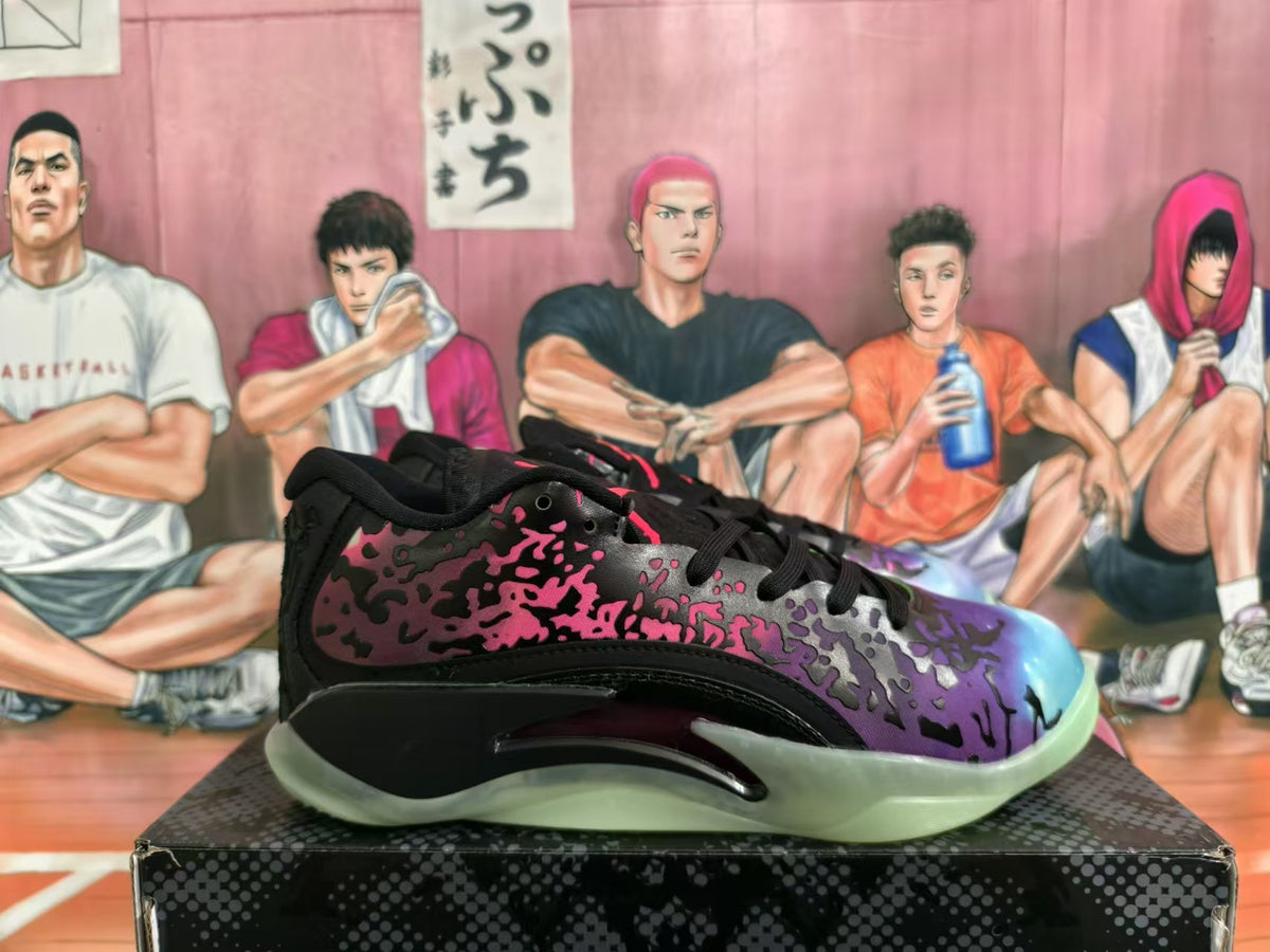 Side view of a Jordan XXXVIII shoe showing the multicolor splatter pattern and translucent outsole
