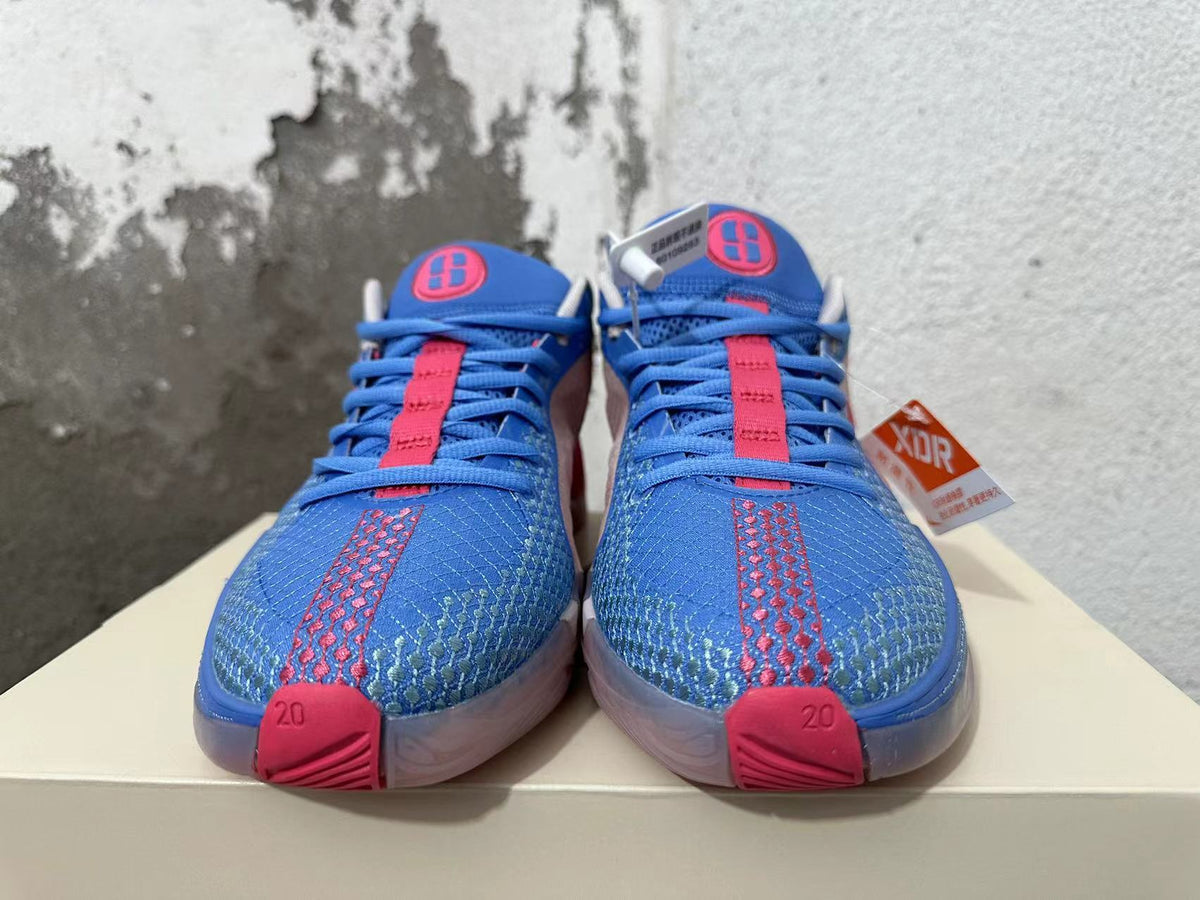Front view of blue and pink Nike Kobe basketball shoes with patterned toe panels and blue laces