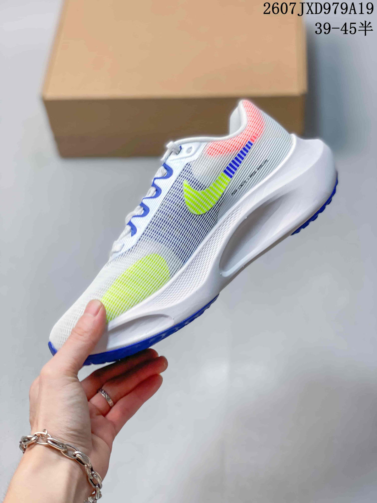 Side view of the white Nike Zoom Fly 5 PRM shoe showing the sculpted midsole, mesh-like upper and colorful Swoosh details.